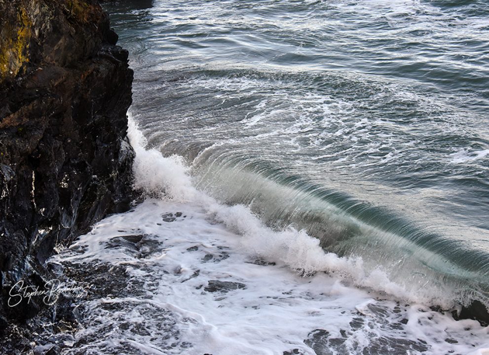 Waves curl on beach